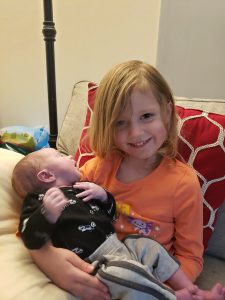 Baby August being held by his big brother