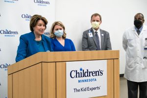 Sen. Amy Klobuchar speaking at a press conference at Children's Minnesota. Also pictured left to right: Janet McGee, Dr. Marc Gorelick, Dr. Andrew Kiragu.