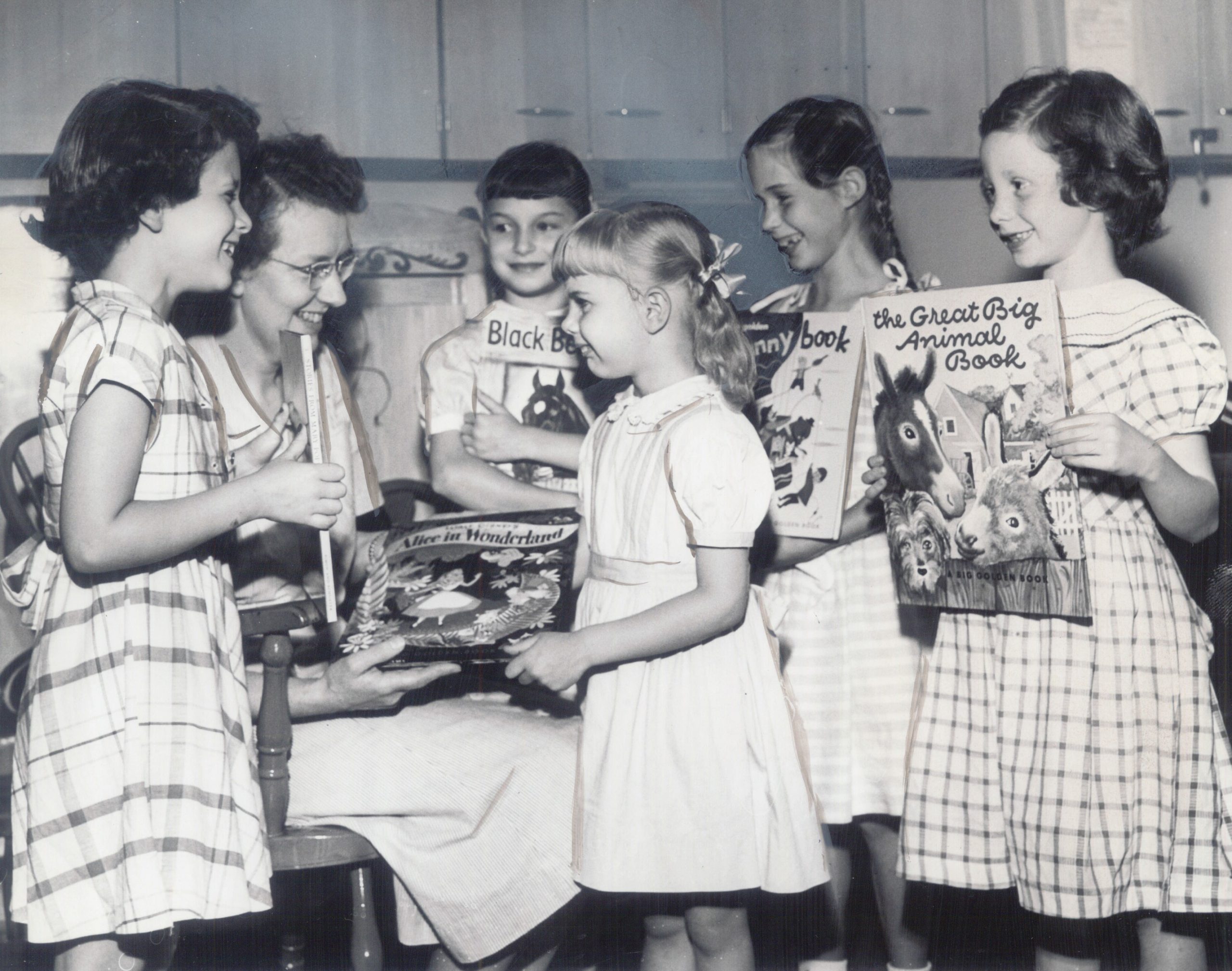 Eleanor Sackett accepts book donations from a group of girls.