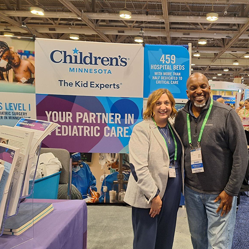 Two Children's Minnesota employees staffing the booth at PAS 2024.