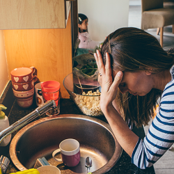 Stressed mom in kitchen that's messy.