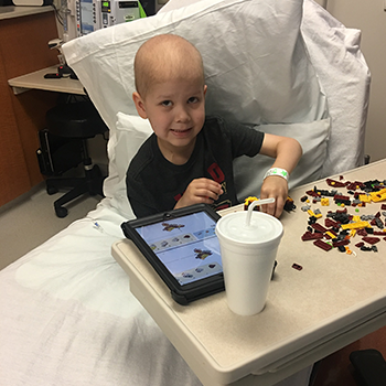 Liam in the hospital playing with toys