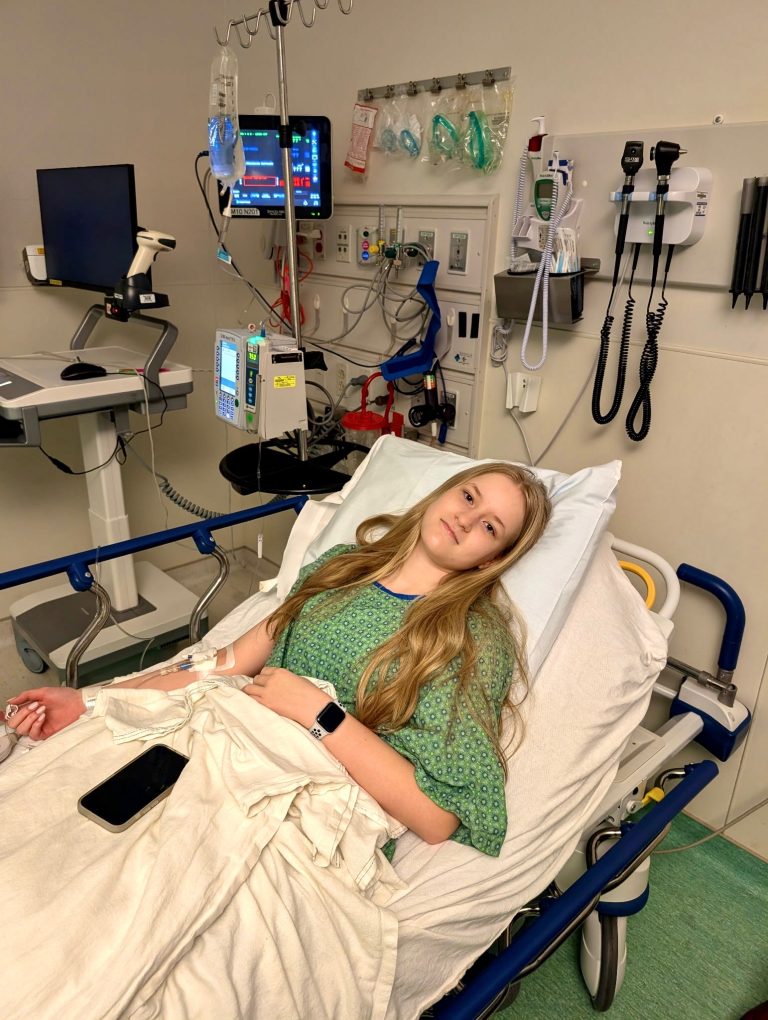 Briella laying in hospital bed