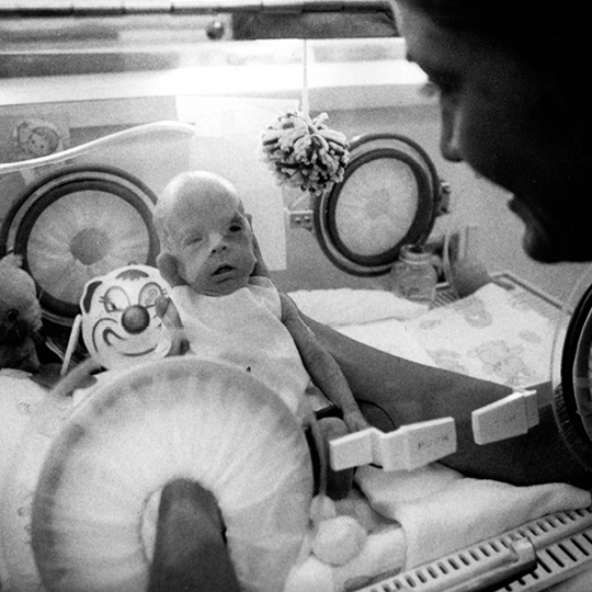 a woman holds a premature baby