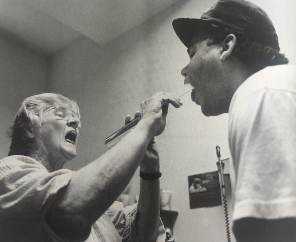 TAMS medical director, Dr. Betty Jerome, examines a patient at the clinic in 1988.