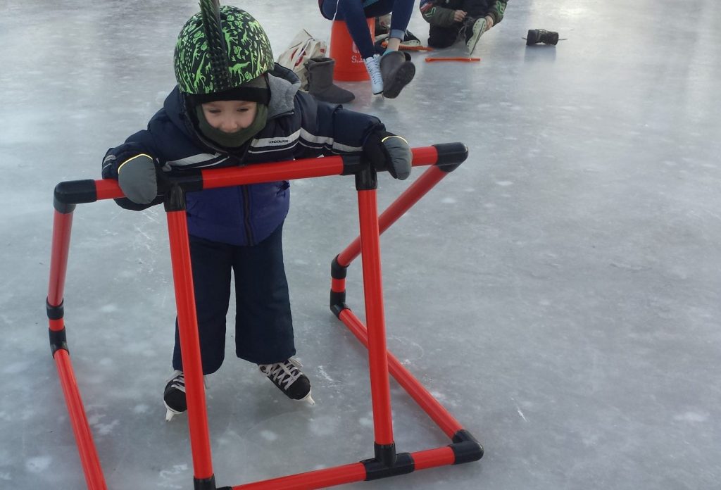 Landon skates with supports as a young child.