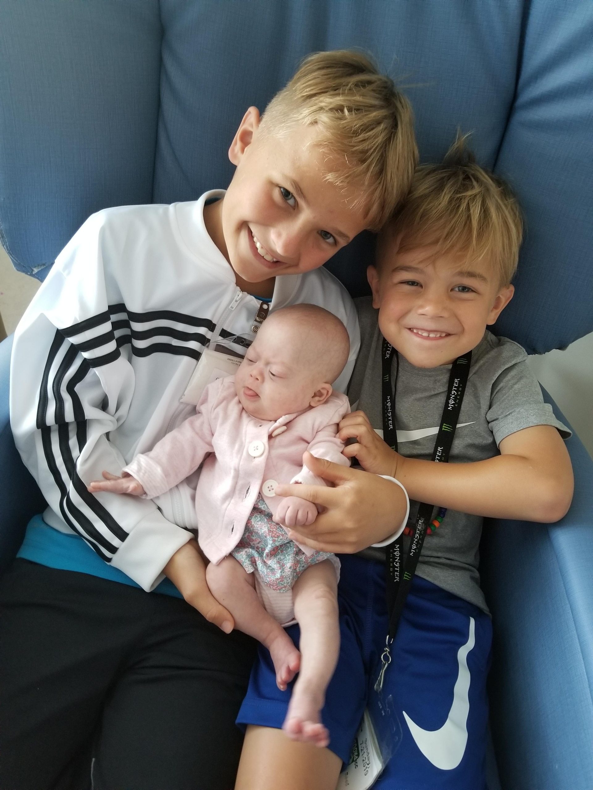 Tallulah and her two older brothers on the couch