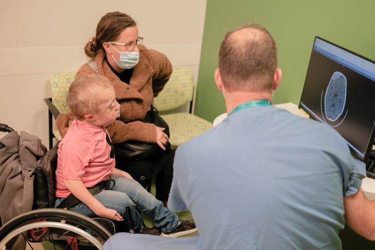 Patient family talking with provider at neurosurgery clinic