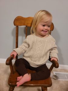 Tallulah sitting on a chair and smiling