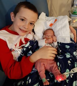 Gabriel holding his brother, Carlisle, in the hospital