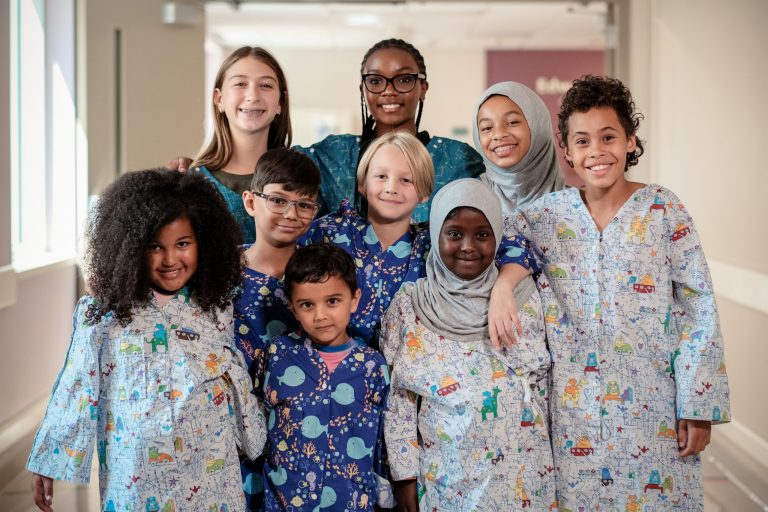 Group of kids wearing modesty gowns.