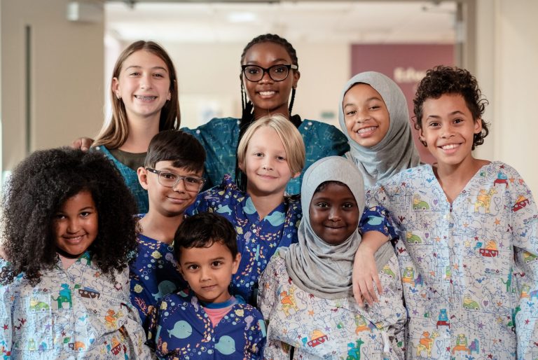 Group of kids wearing modesty gowns.