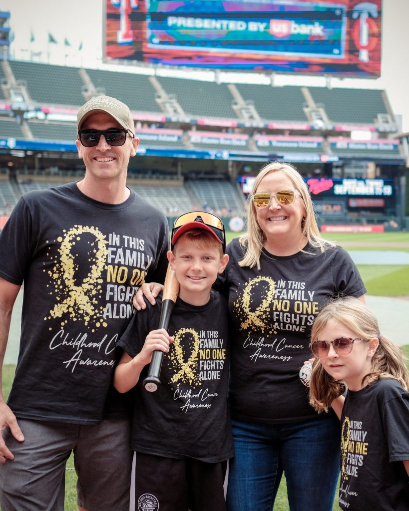 Riley and his family at a Twins game in matching T-shirts.