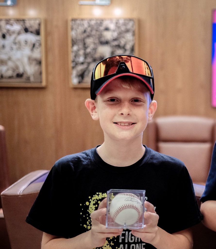 Riley holding a signed Twins baseball