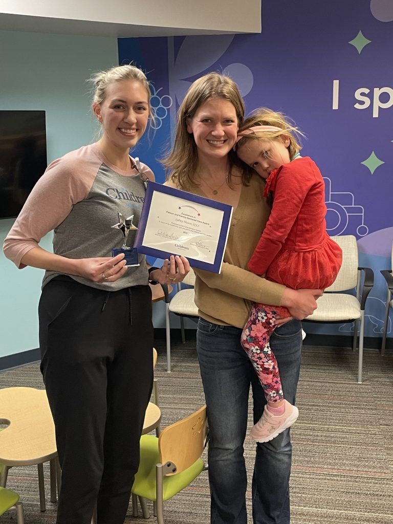 Sydney Weaver, child life specialist, with patient family