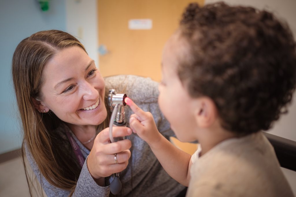 Abby Meyer, MD, MPH, senior medical director of surgical specialties and pediatric otolaryngologist with Children’s Minnesota, with a patient