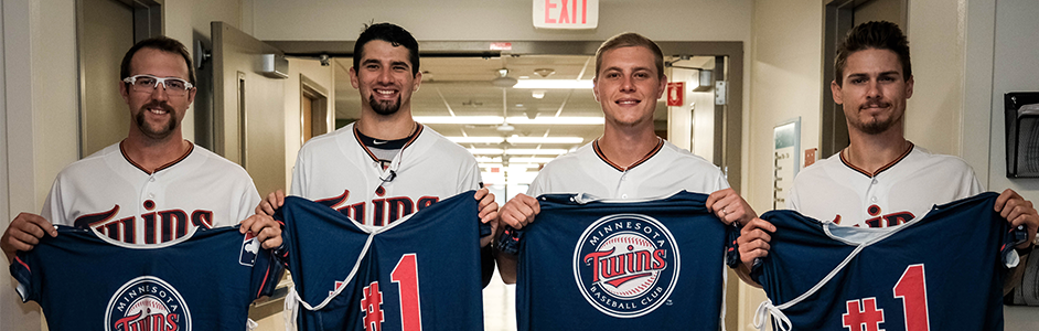 Twins players holding up their jerseys in the Children's Minnesota hospital