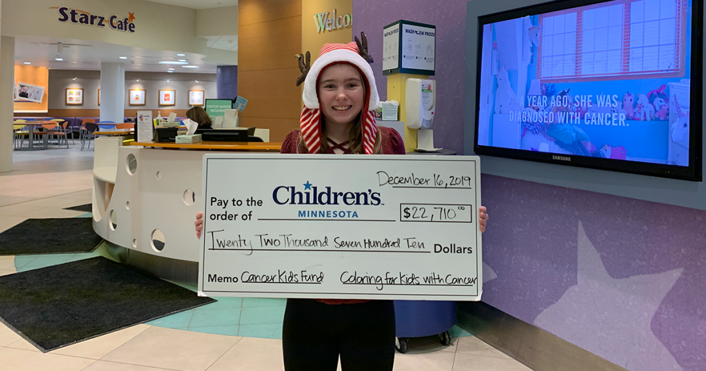 Addie with her donation of $22