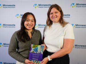 Mai Songsawatwong, social media specialist, and Alex Erritt, manager of social media, pose with MHA award.