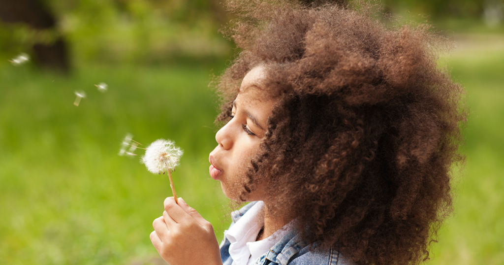 Little girl outside with summer allergies.