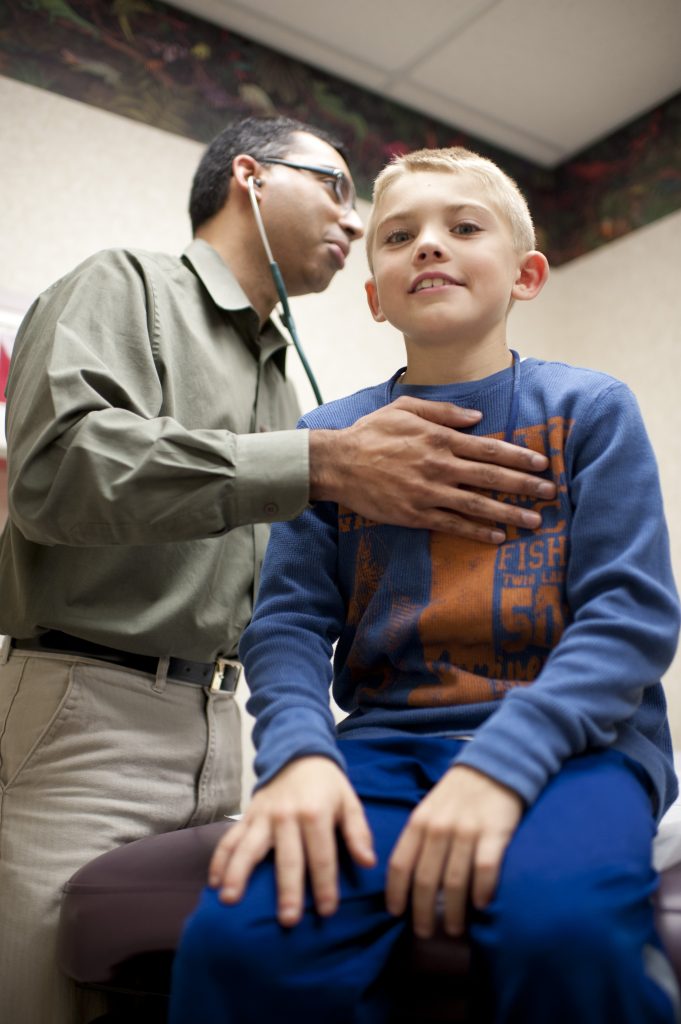 Young boy with Children's Minnesota doctor at a primary care appointment
