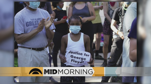 Minnesota child holding up sign that requests justice for George Floyd.