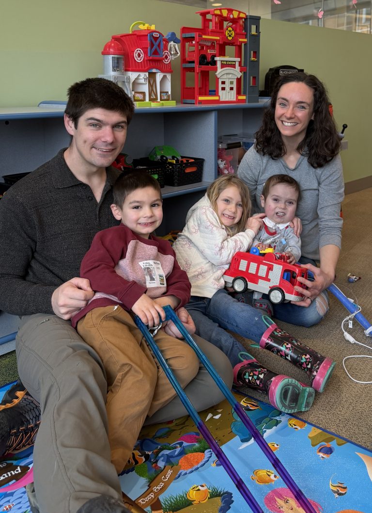 Peter and Ashley Boman with their children, Connor, Melody and Archer playing in the Sibling Play Area of the Children's Minnesota hospital in Minneapolis.