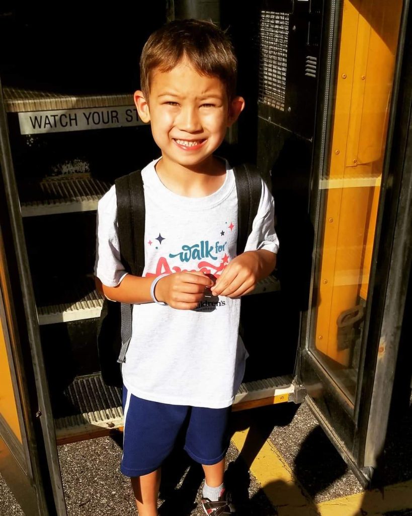 Asher Thomas with a backpack on going to school