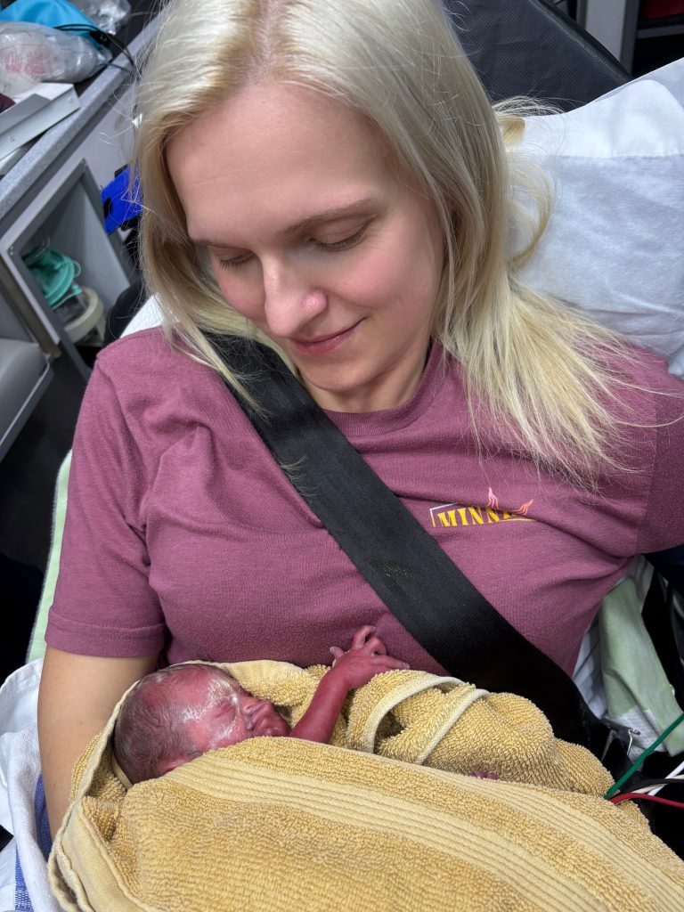 Brittney holds newborn baby Owen in an ambulance.