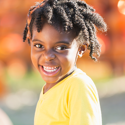 Little Black girl in a pumpkin patch