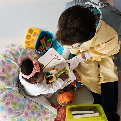 Employee reading to patient Employee reading to patient