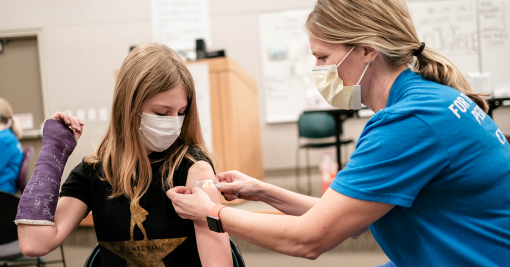 child getting a COVID-19 booster vaccine