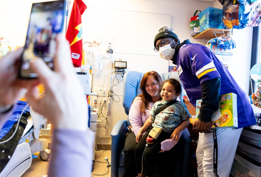 Brandon Powell visiting a patient in their room