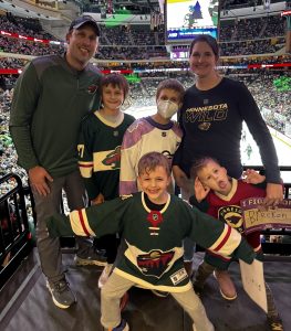 Breckon and his parents and brothers posing at the Minnesota Wild Hockey Fights Cancer game