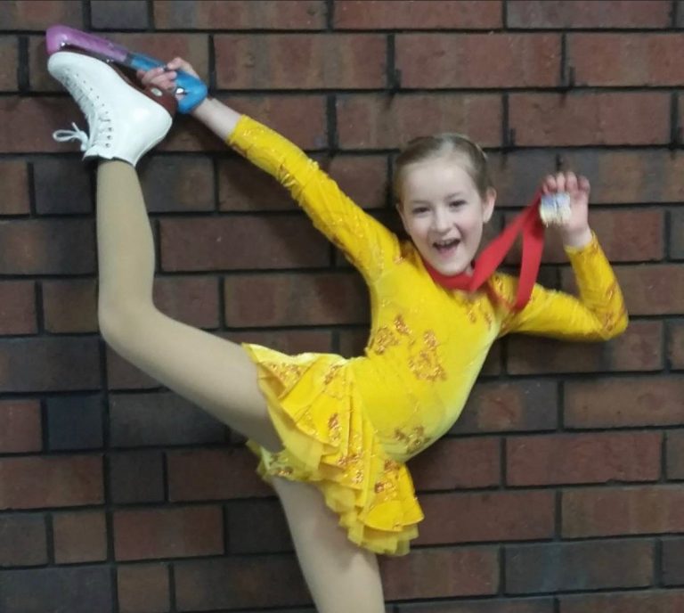 Briella with her figure skating medal