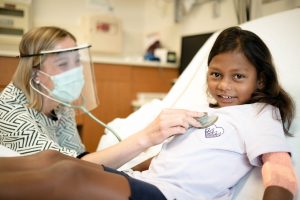Provider checking on young patient