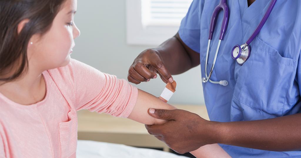 Child getting a flu shot from a doctor