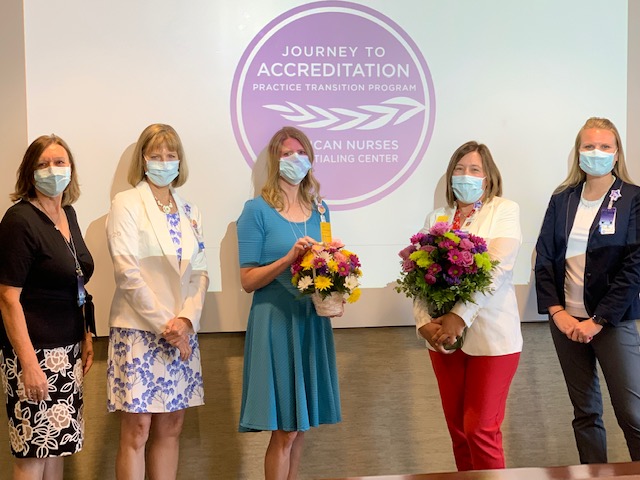 Children’s Minnesota nurses standing up holding flowers at the award ceremony