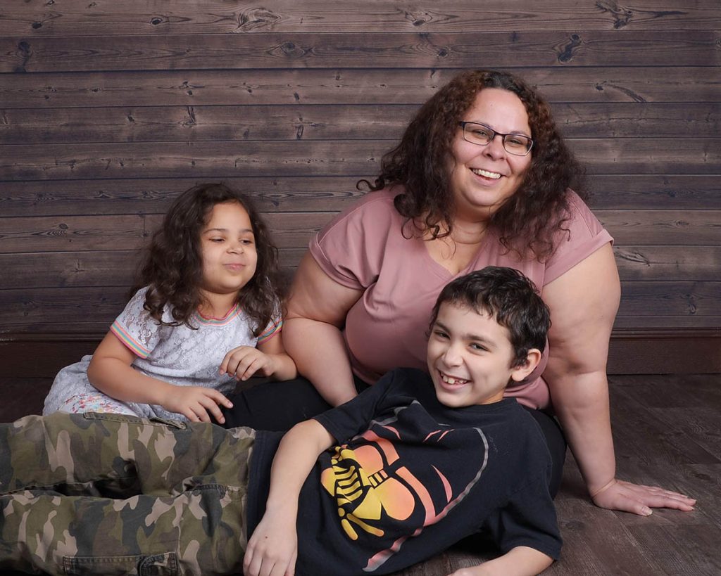 Portrait of the Claudio family smiling