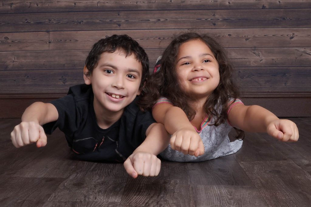 Ezekiel and Ariana strike superhero poses