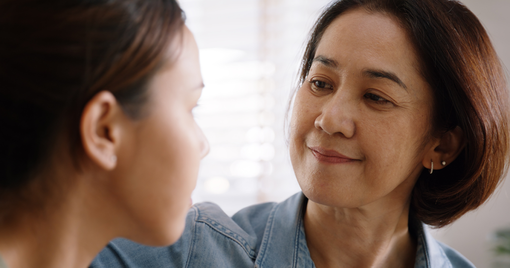 Mother and teen daughter together talking about coming out