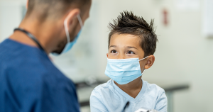 Kid at the doctor about to get a COVID-19 test.