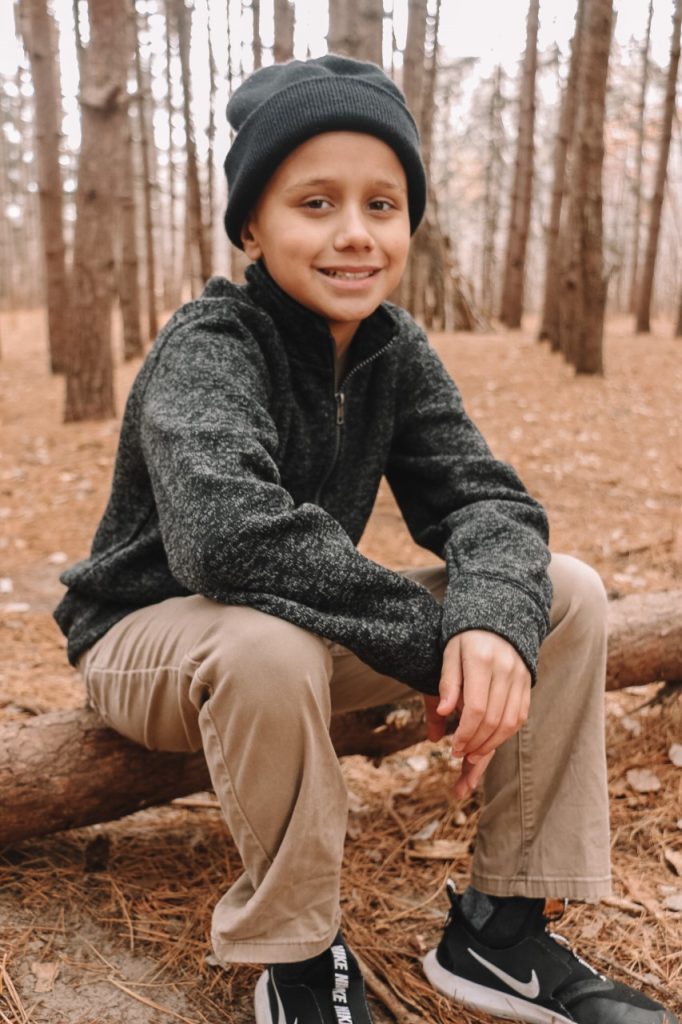 Patient Cullen in a forest||Cullen Cisneros and siblings in forest|||Cullen doing music therapy in his hospital room at Children's Minnesota