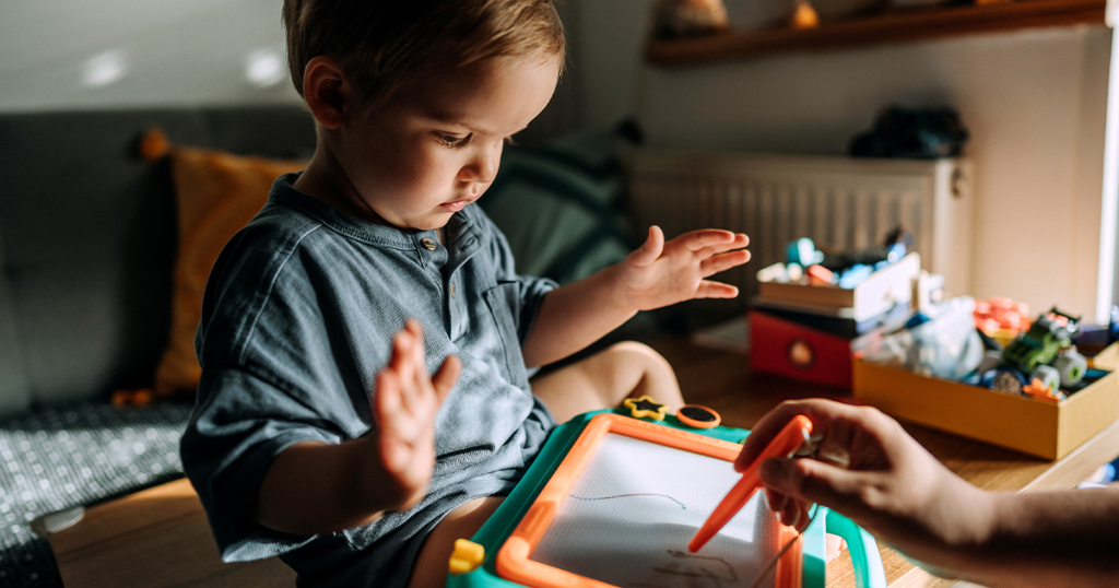 Child playing with a magic board