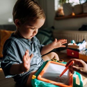 toddler and mom drawing on toy