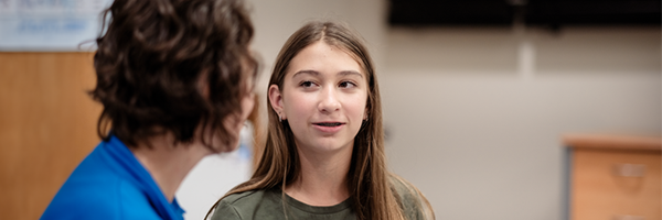 Teenage girl looking at her doctor, talking about the importance of diabetes care