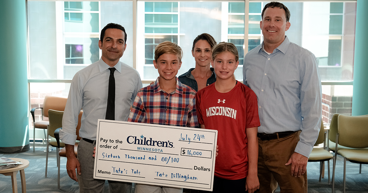 The Dillingham Family and Dr. Kebriaei presenting their donation with a big check
