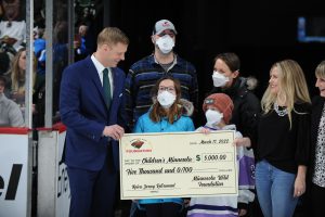 Mikko Koivu, joined by Jack, presents check to Children's Minnesota