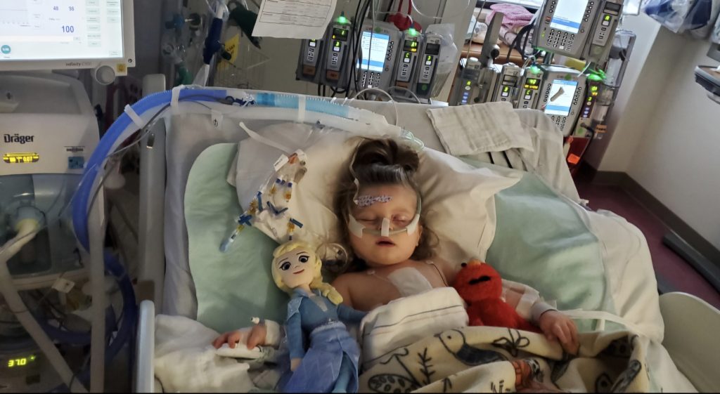 Evelyn as a baby in a hospital bed.