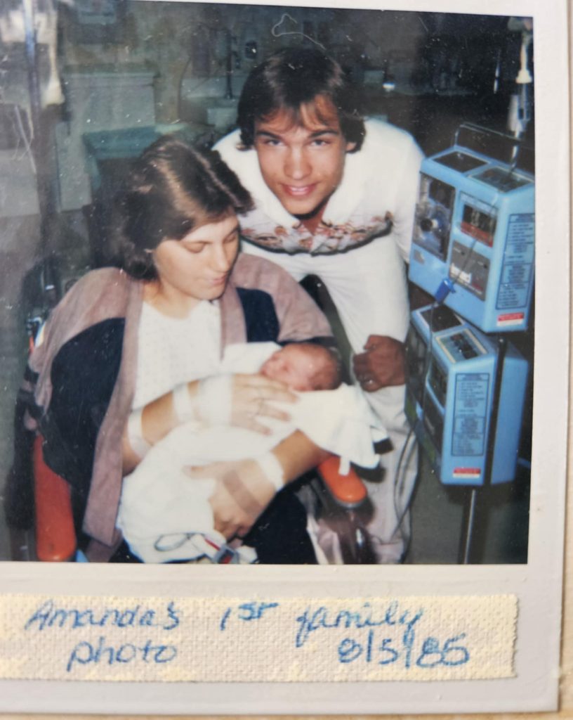 Amanda as a newborn in the hospital with her parents